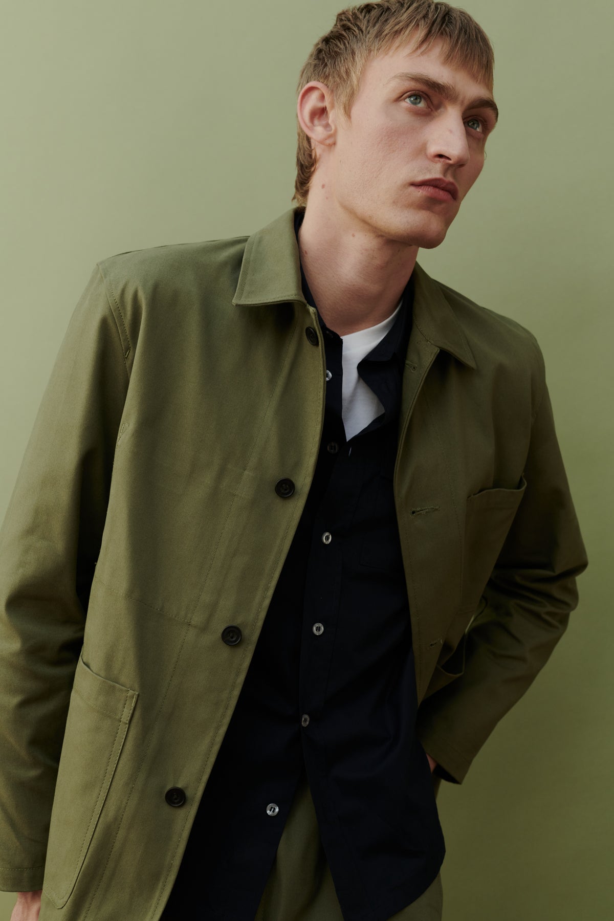 
            Image of white male, waist up wearing men&#39;s chore jacket in olive