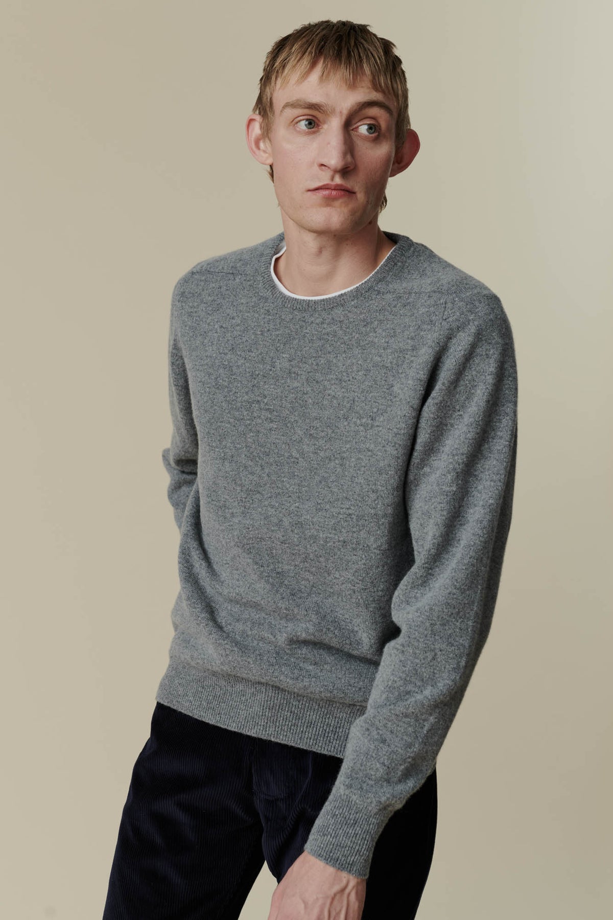 
            White male wearing grey lambswool crew neck