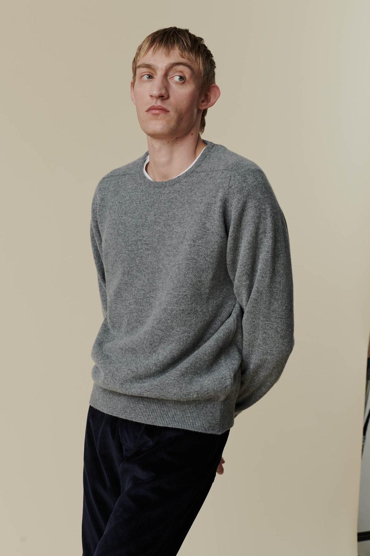 
            White male wearing grey lambswool crew neck