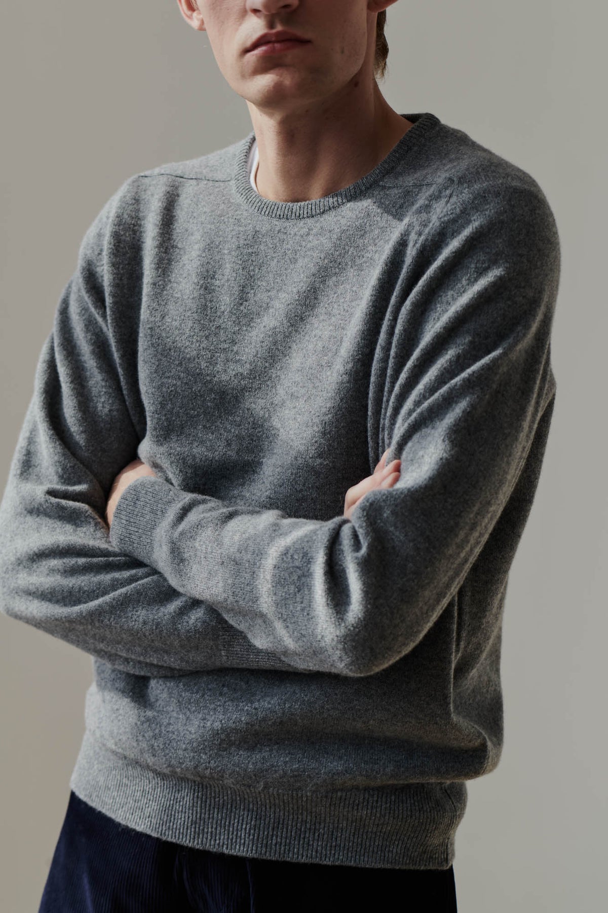 
            White male wearing grey lambswool crew neck