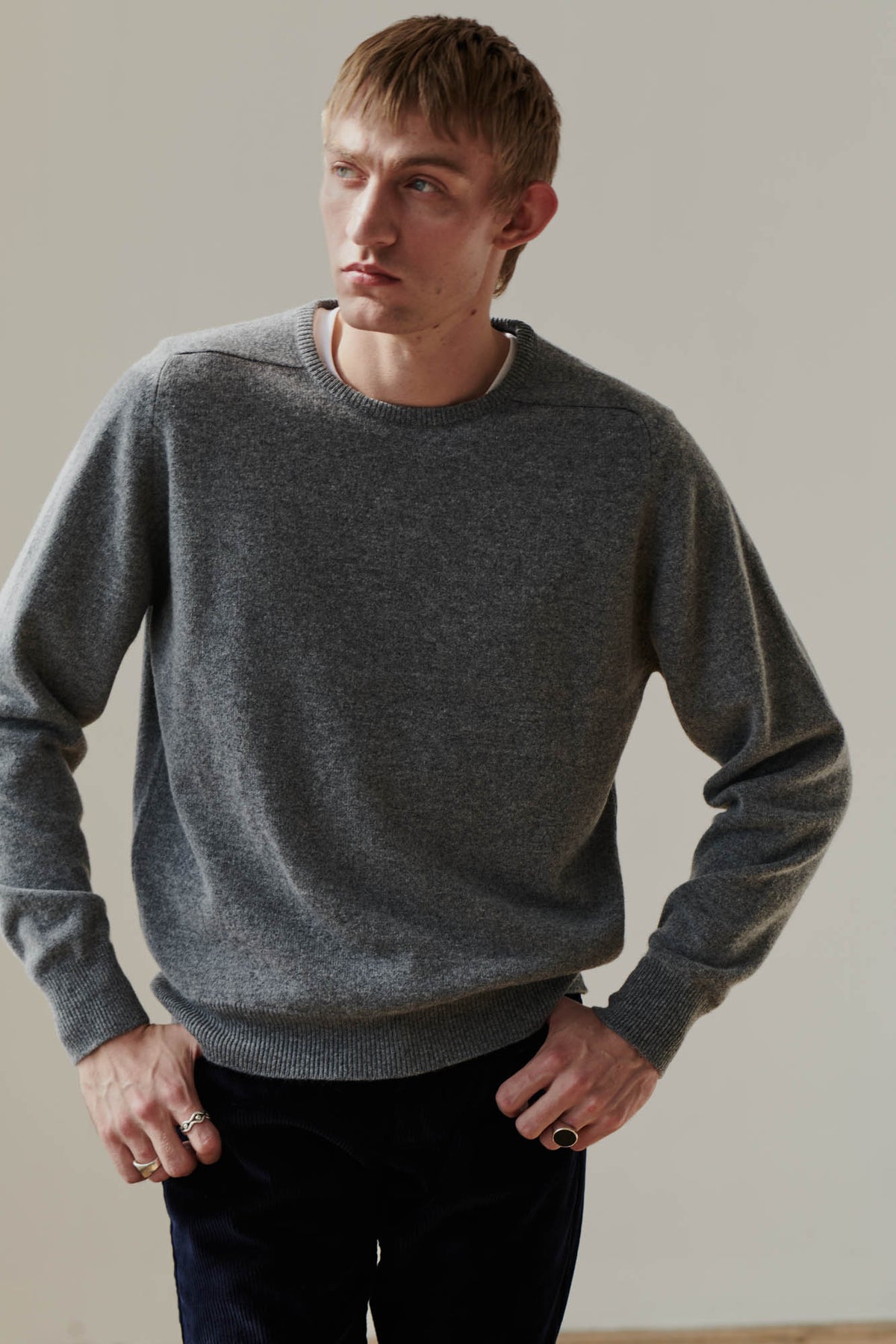 
            White male wearing grey lambswool crew neck