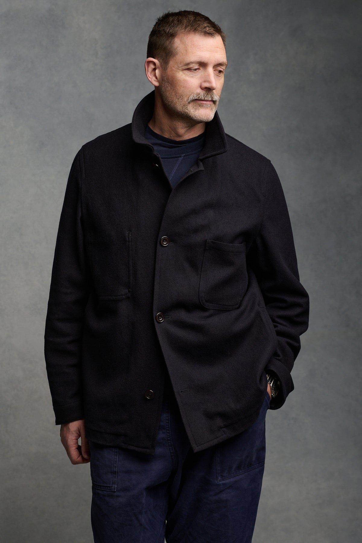 
            Our founder Patrick Grant wearing men&#39;s Arthur wool chore jacket in navy, with the collar up